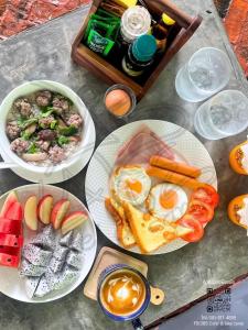 a table topped with plates of breakfast foods and drinks at 385 Glamping in Ban Khai Nao (1)