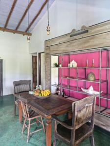 a dining room with a wooden table and chairs at Casa da Briana in Trancoso