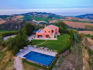 an aerial view of a house with a swimming pool at Relais Tenuta Santori in Cossignano +18 photos