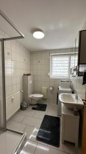 a bathroom with a sink and a toilet at Ferienwohnung Stadtblick in Arneburg