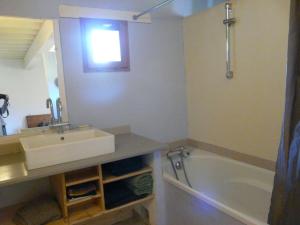 a bathroom with a sink and a bath tub at Ferme de la Rose in Rosans