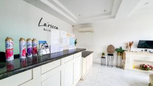 a white room with a counter with a shelf at La'Rissa Residence by ARBA in Karawang