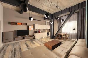 a living room with a couch and a table at ArtHomes Apartments in Timişoara
