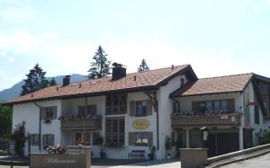 a large white building with a roof at Gästehaus Wolfgang Chiemsee -1- in Ruhpolding +10 photos