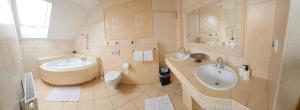 a bathroom with a sink and a toilet and a tub at Dom Noclegowy Wiktoria in Skrzyszów +19 photos