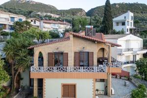 a house with a balcony on top of it at Villa Nerea in Kitriaí +53 photos