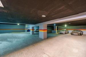 a parking garage with two cars parked in it at Élégance et Prestige à Gueliz Appartement 3 chambres in Marrakech