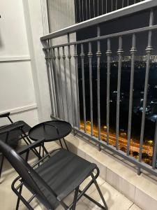 a balcony with two chairs and a view of the city at QM House 08 in Hanoi