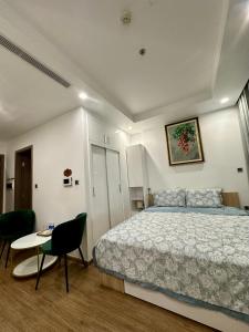 a bedroom with a bed and a table and chairs at QM House 08 in Hanoi