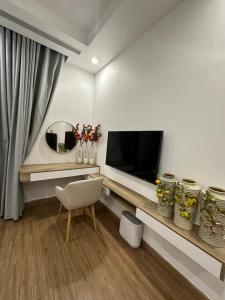 a living room with a television and a chair at QM House 08 in Hanoi