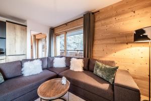 - un salon avec un canapé et un mur en bois dans l'établissement Maira Les Carroz - by EMERALD STAY, à Arâches-la-Frasse 36 autres photos
