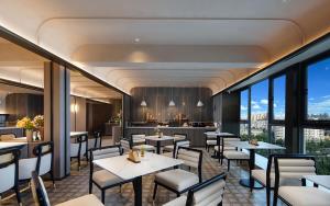 a restaurant with tables and chairs and a bar at Atour Hotel Kunming Changshui International Airport Cloud Cube in Kunming