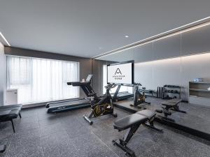 a gym with treadmills and exercise equipment in a room at Atour Hotel Kunming Changshui International Airport Cloud Cube in Kunming