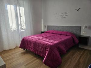Postel nebo postele na pokoji v ubytování L'arancio B&B