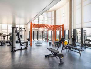 a gym with cardio equipment in a large building at 405 - Rentaqui Apartamento The Prime Moema in Sao Paulo