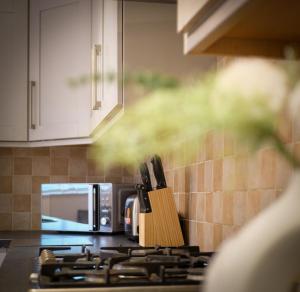 a kitchen counter with a stove top with a microwave at Spacious 5B Sunderland Home for Groups & Families in Sunderland