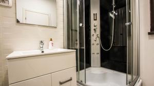 ein Badezimmer mit Waschbecken und Dusche in der Unterkunft Panoramic de lux Mihai Bravu cu internet de mare viteza si parcare gratuit in Bukarest + 19 Fotos