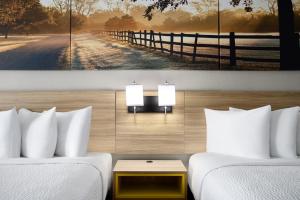 a room with two beds and a fence at Quality Inn Waycross in Waycross