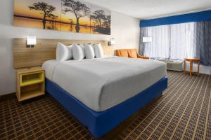 a hotel room with a large bed in a room at Quality Inn Waycross in Waycross