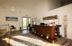 a living room with a counter and a table at Il Vigneto Resort in Menfi