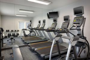 a gym with several treadmills and elliptical machines at TownePlace Suites by Marriott Orlando East/UCF Area in Orlando