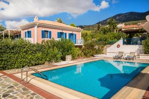 a villa with a swimming pool and a house at Villa Rudi in Trapezaki
