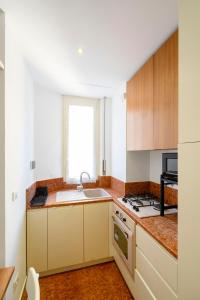 a kitchen with a sink and a stove at Sognando Vacanze Romane in Rome +17 photos