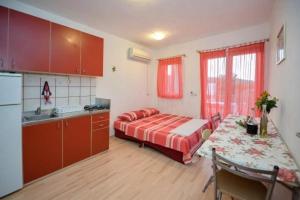 a kitchen with a bed and a table in a room at Ferienwohnung in Luka mit Meerblick, Terrasse, Klimaanlage, W-LAN 4659-1 in Luka +27 photos