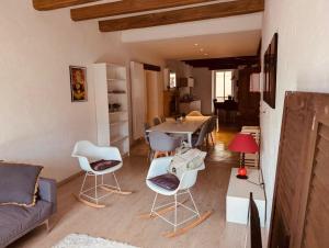 a living room with a couch and chairs and a table at La Mariefacture comme un charme in Haute-Vigneulles