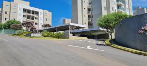 an empty street in a city with tall buildings at Assinatura Mensal in Bragança Paulista