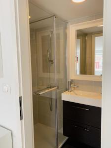 a bathroom with a glass shower and a sink at Casa Porto in Piran