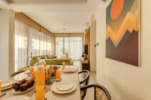 a living room with a table and a couch at Casa Solace 3 BHK by tisyastays in Assagao