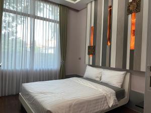 Postelja oz. postelje v sobi nastanitve Huang Su Villa 5 皇宿5号泳池别墅 + 11 fotografij