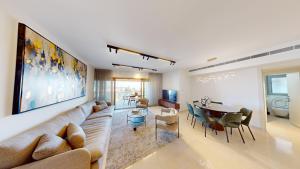 a living room with a couch and a table at KING DAVID RESIDENCES - Pool & Gym in Jerusalem
