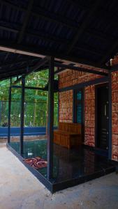 a porch with a bench in a brick building at Prakruthi Home stay in Kanjikode
