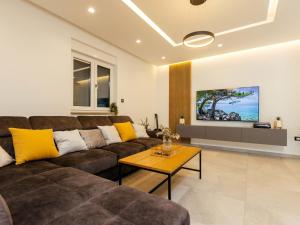 a living room with a couch and a table at Holiday Home Lozo by Interhome in Gornji Proložac +31 photos