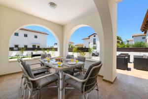 a dining room with a table and chairs at Kymma Villa #12 in Ayia Napa