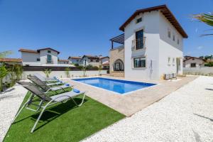 a villa with a swimming pool and a house at Kymma Villa #12 in Ayia Napa
