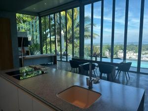 a kitchen with a sink and a counter with a view at Phuket 4-Bedrooms Seaview 884m2 Private XL Luxury Infinity Pool Villa in Ban Pa Khlok