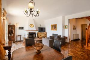 a living room with a table and a couch at Villa Anastasia in Corfu