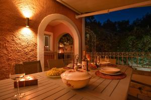 a table with a cake on top of a deck at Villa Anastasia in Corfu