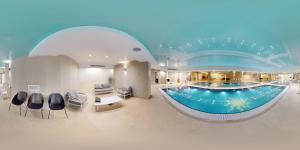a lobby with a large swimming pool in a building at KING DAVID RESIDENCES - Pool & Gym in Jerusalem