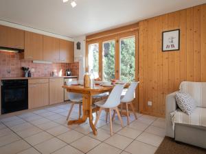 オヴロナにあるApartment Seya 15 by Interhomeのテーブルと椅子のあるキッチンとダイニングルーム