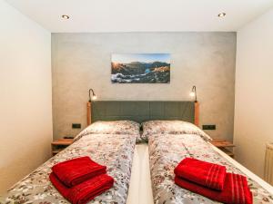 a bedroom with two beds and two red pillows at Apartment Stöckl by Interhome in Schwendau