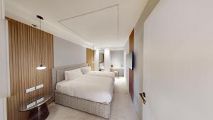 a bedroom with a white bed in a room at KING DAVID RESIDENCES - Pool & Gym in Jerusalem +143 photos