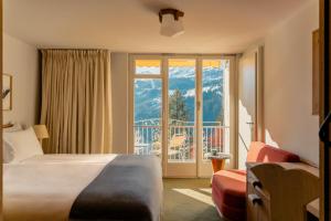 翁根Grand Hotel Belvedere, a Beaumier Hotel的一间带床和大窗户的酒店房间