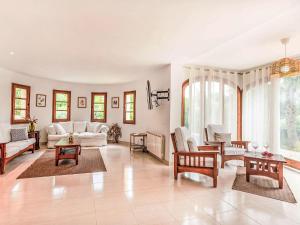 a large living room with white furniture and windows at Holiday Home Villa Brava by Interhome in Calonge