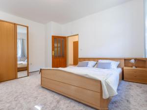 a bedroom with a large bed and a mirror at Holiday Home Villa Weber by Interhome in Albrechtice v Jizerských horách