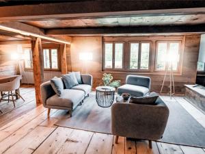 a living room with two chairs and a couch at Apartment Chalet Solegg by Interhome in Innertkirchen +13 photos