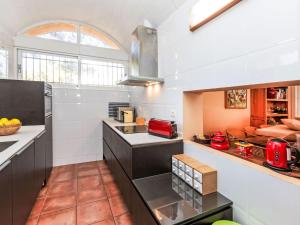 a kitchen with white walls and a large window at Villa Platja Calafato by Interhome in L'Ametlla de Mar +24 photos